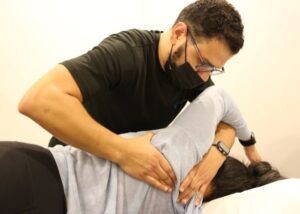 Mina Messeha, a physiotherapist is treating the shoulder of a woman by using a mobilization technique to help decompression the shoulder. Mobilizations are used by physiotherapists and chiropractors to reduce pressure in a joint and increase range of motion.