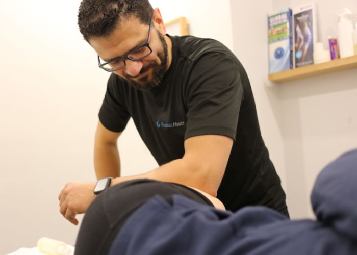 A physiotherapist, Mina Messeha, at Runway Health in Markham or Newmarket, is providing soft tissue release techniques to a patient's hip. Soft tissue therapy is a common treatment technique used by most physiotherapists to help with muscle tension and provide pain relief.